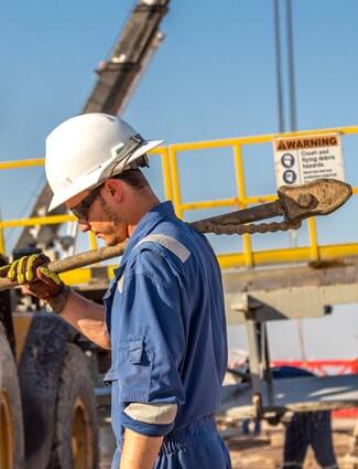 Oil worker wearing PPE, including a hard hat